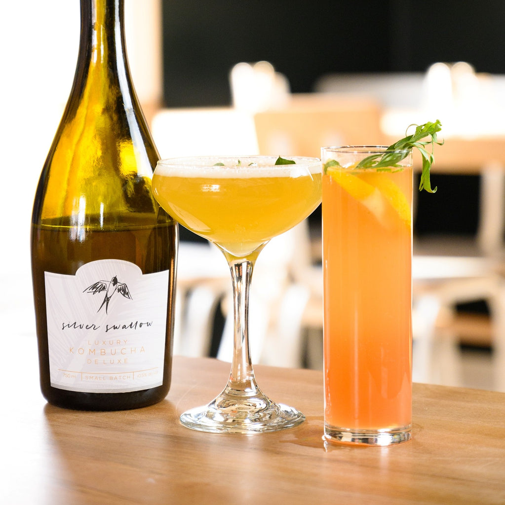Beachcomber and Minosa non-alcoholic cocktails in front of a bottle of Silver Swallow Luxury Kombucha